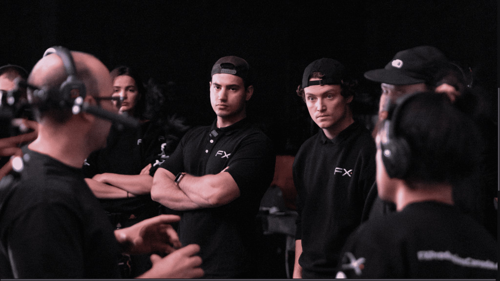 A group of men wearing black shirts and hats, standing together.